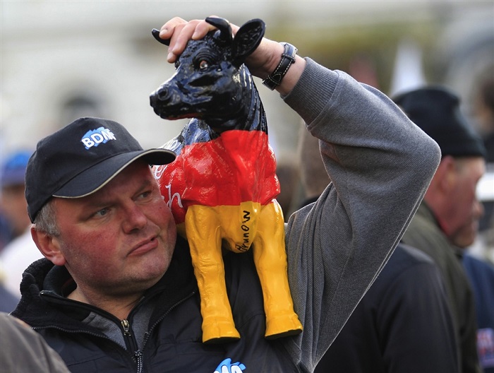 Bizarre Protests Dairy Farmer With Cow