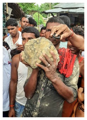 © STR/AFP/Getty Images A villager holds the suspected meteorite.