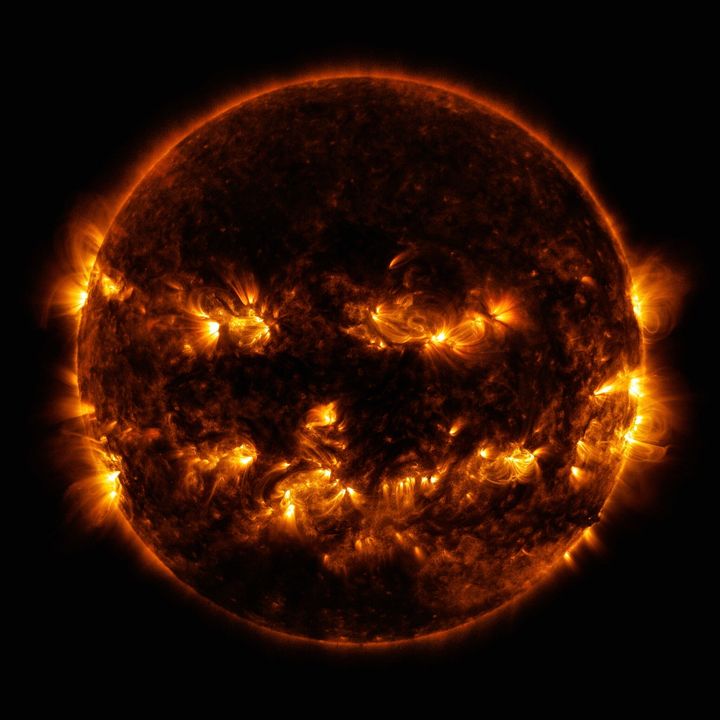 In this Oct. 8, 2014 photo released by NASA, active regions on the sun combine to look something like a jack-o-lantern’s face