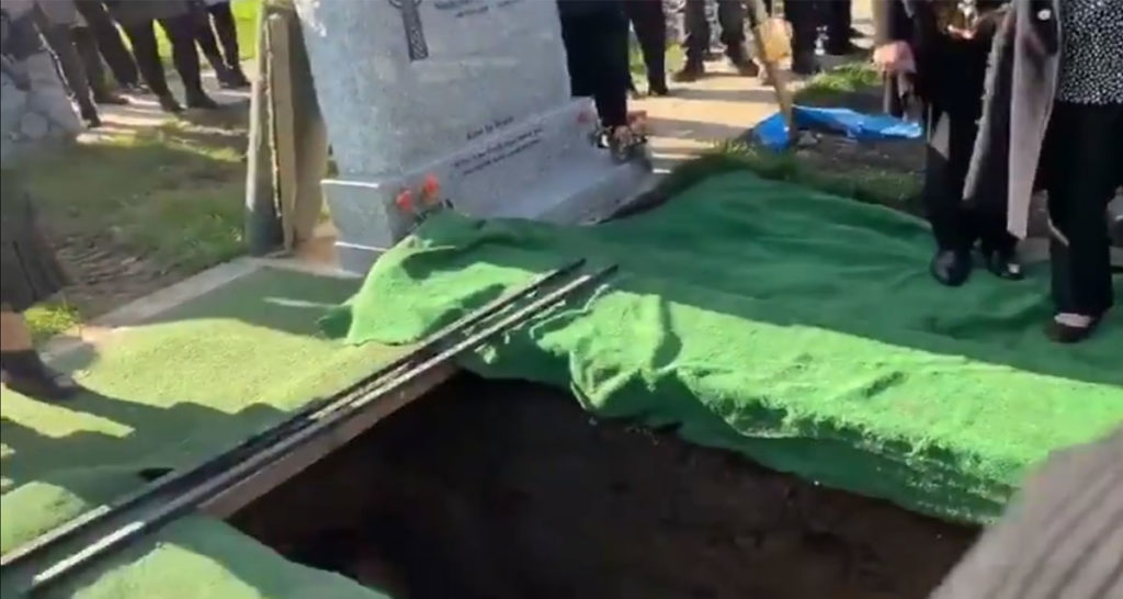 Dead Guy Pranks Mourners as He's Lowered into the Ground 1