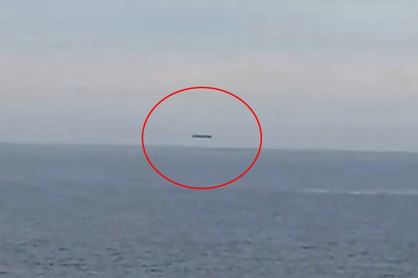 A huge cylindrical UFO is filmed over the Welsh sea 6