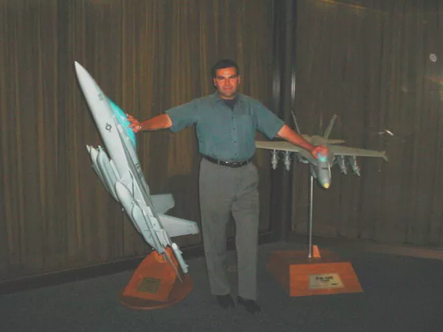 The alleged image of Salvatore Pais, standing among the large Super Hornet and Growler models.