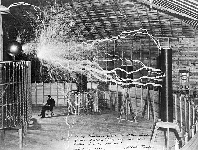 Tesla in front of a high frequency transformer at the Colorado Springs lab.